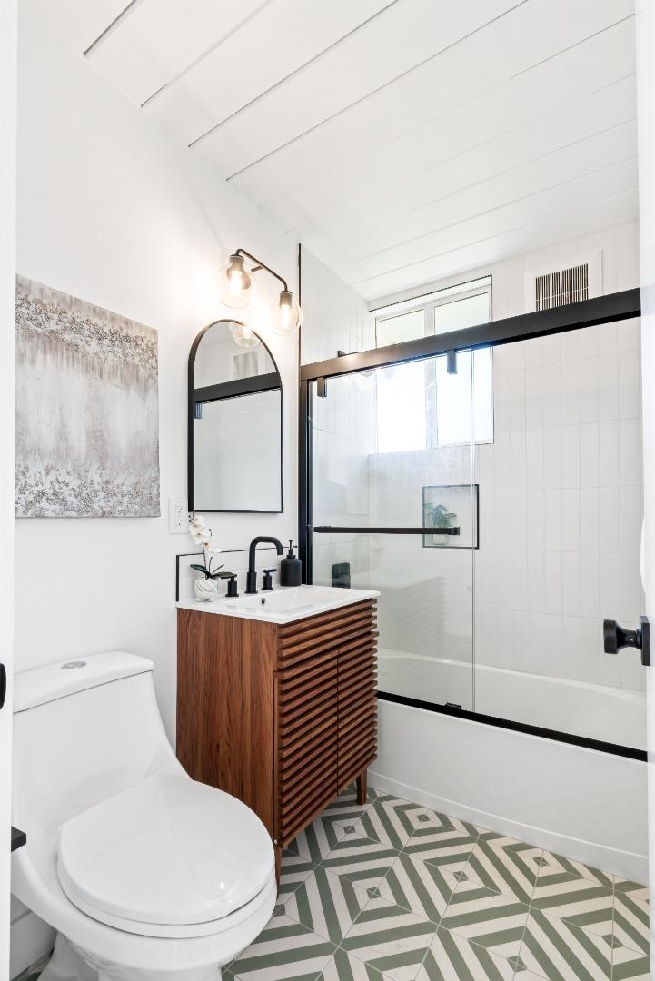 1714 Celeste Drive San Mateo, CA 94402 - Photo 32 of 45 a bathroom with a sink mirror vanity and toilet