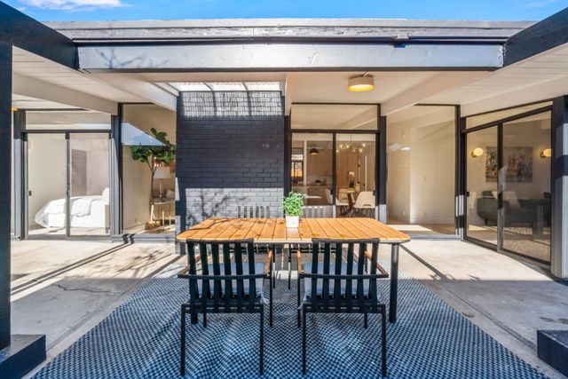 a view of a porch with a table and chairs