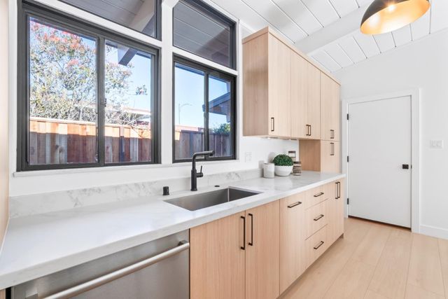 a dining room with furniture and a floor to ceiling window