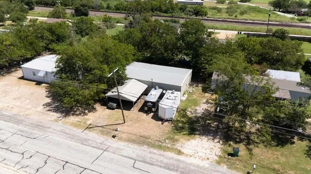 an aerial view of a house with garden space and lake view