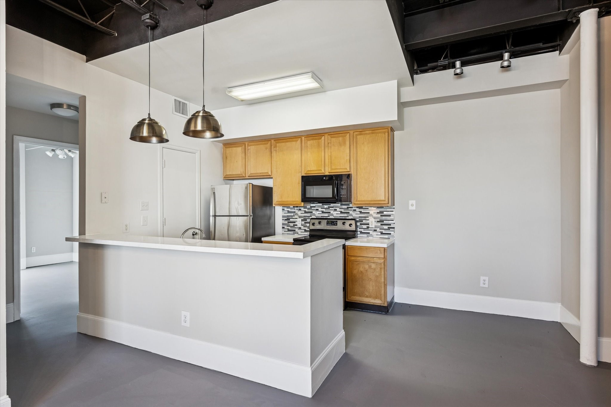 a kitchen with stainless steel appliances a refrigerator and a stove top oven