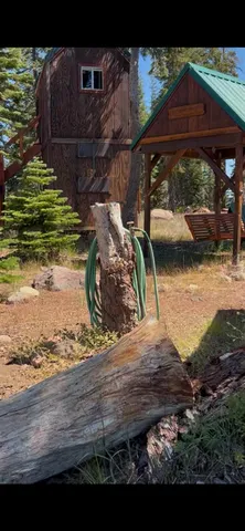 a view of a dry yard with wooden fence