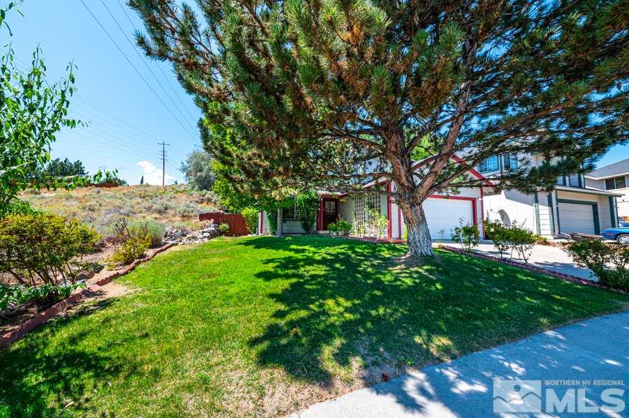 3930 Aspendale Drive Reno, NV 89503 - Photo 4 of 26 a front view of a house with a garden and tree