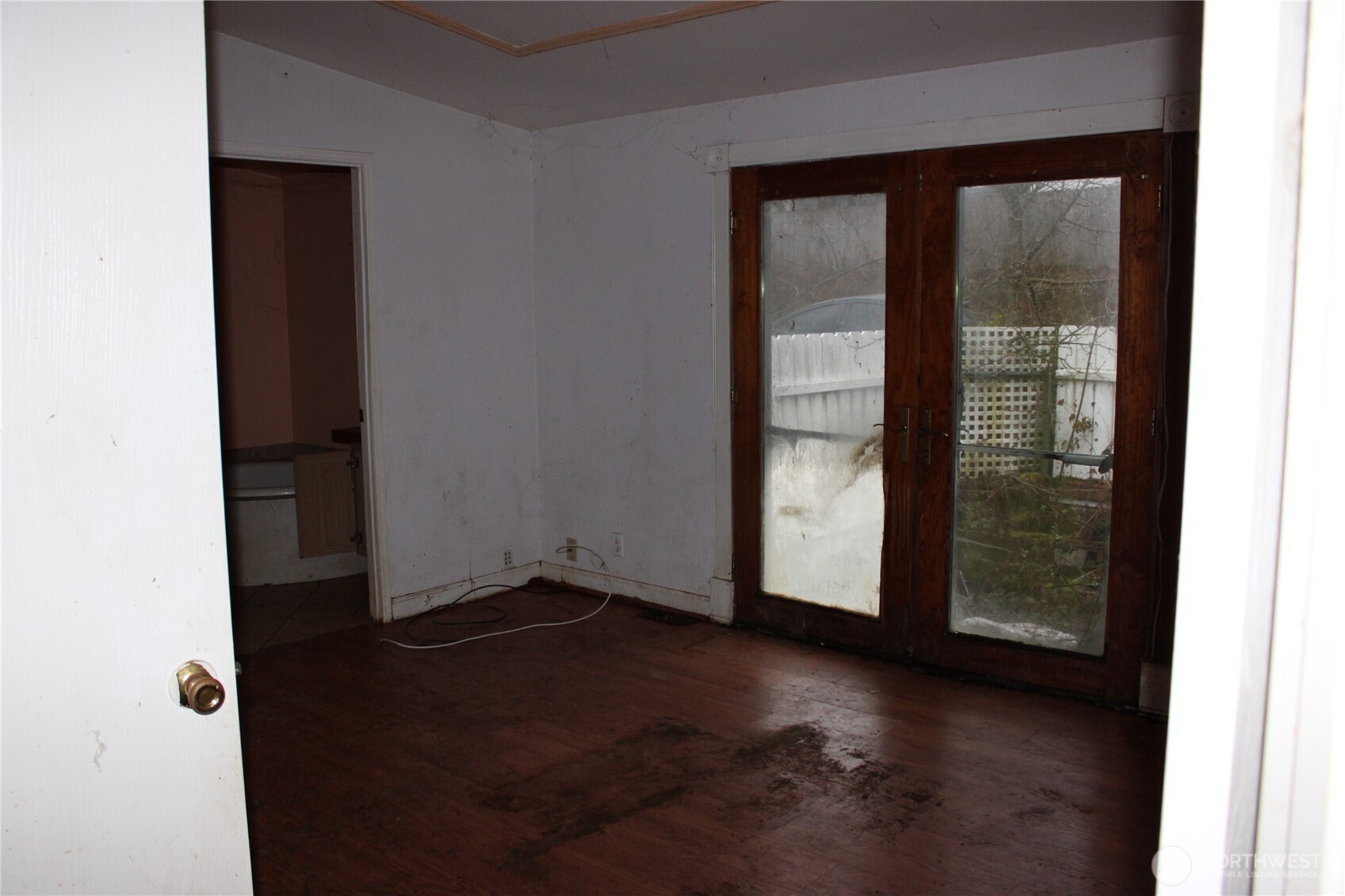416 Main Street Vader, WA 98593 - Photo 6 of 22 an empty room with wooden floor and windows
