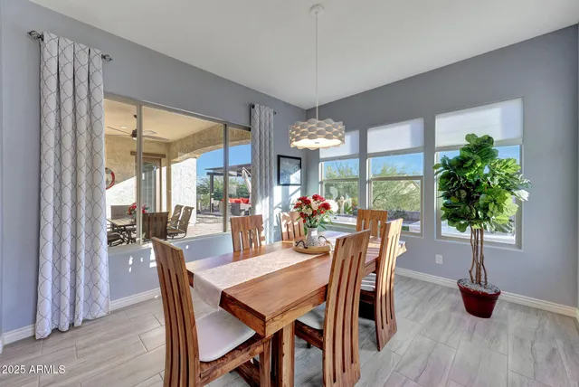 a dining room with furniture window outside view and wooden floor
