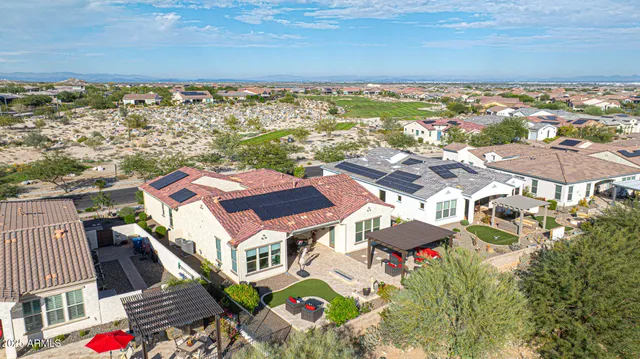 an aerial view of residential houses with outdoor space and city view