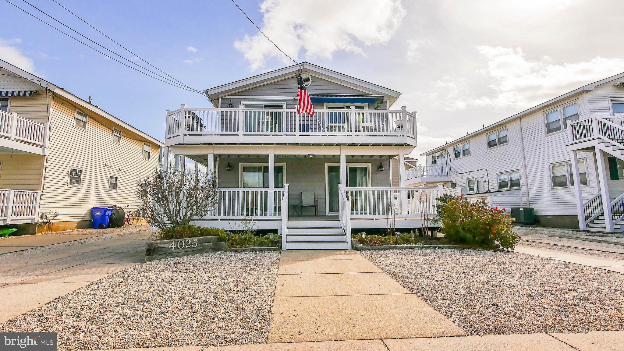 4025 4th Avenue Avalon, NJ 08202 - Photo 1 of 32 a front view of a house with garden