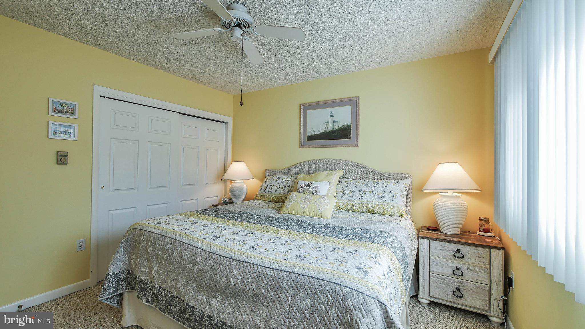 4025 4th Avenue Avalon, NJ 08202 - Photo 17 of 32 a bedroom with a bed and a lamp