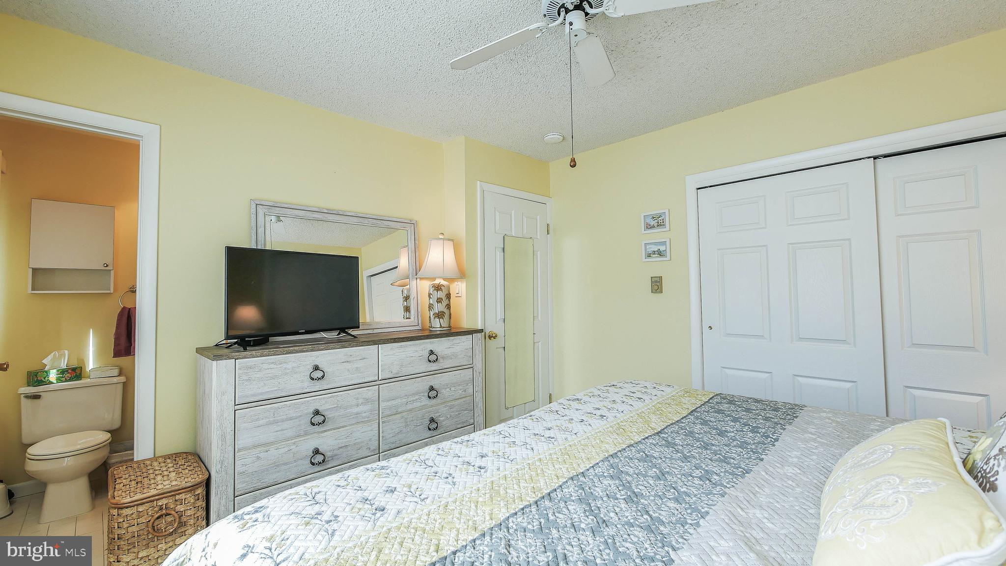 4025 4th Avenue Avalon, NJ 08202 - Photo 18 of 32 a bedroom with a bed and a flat screen tv