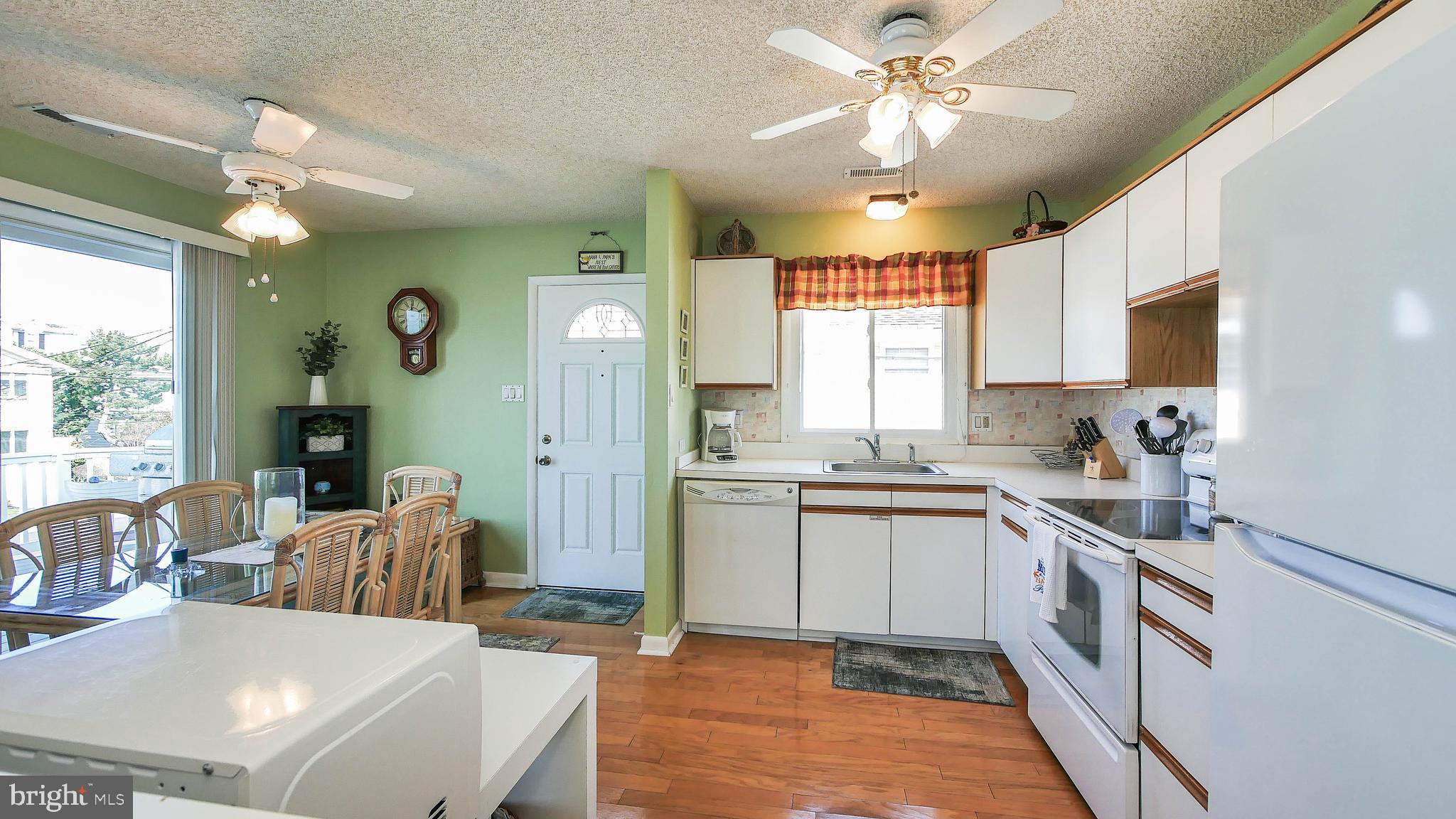 4025 4th Avenue Avalon, NJ 08202 - Photo 20 of 32 a kitchen with a sink stove and cabinets