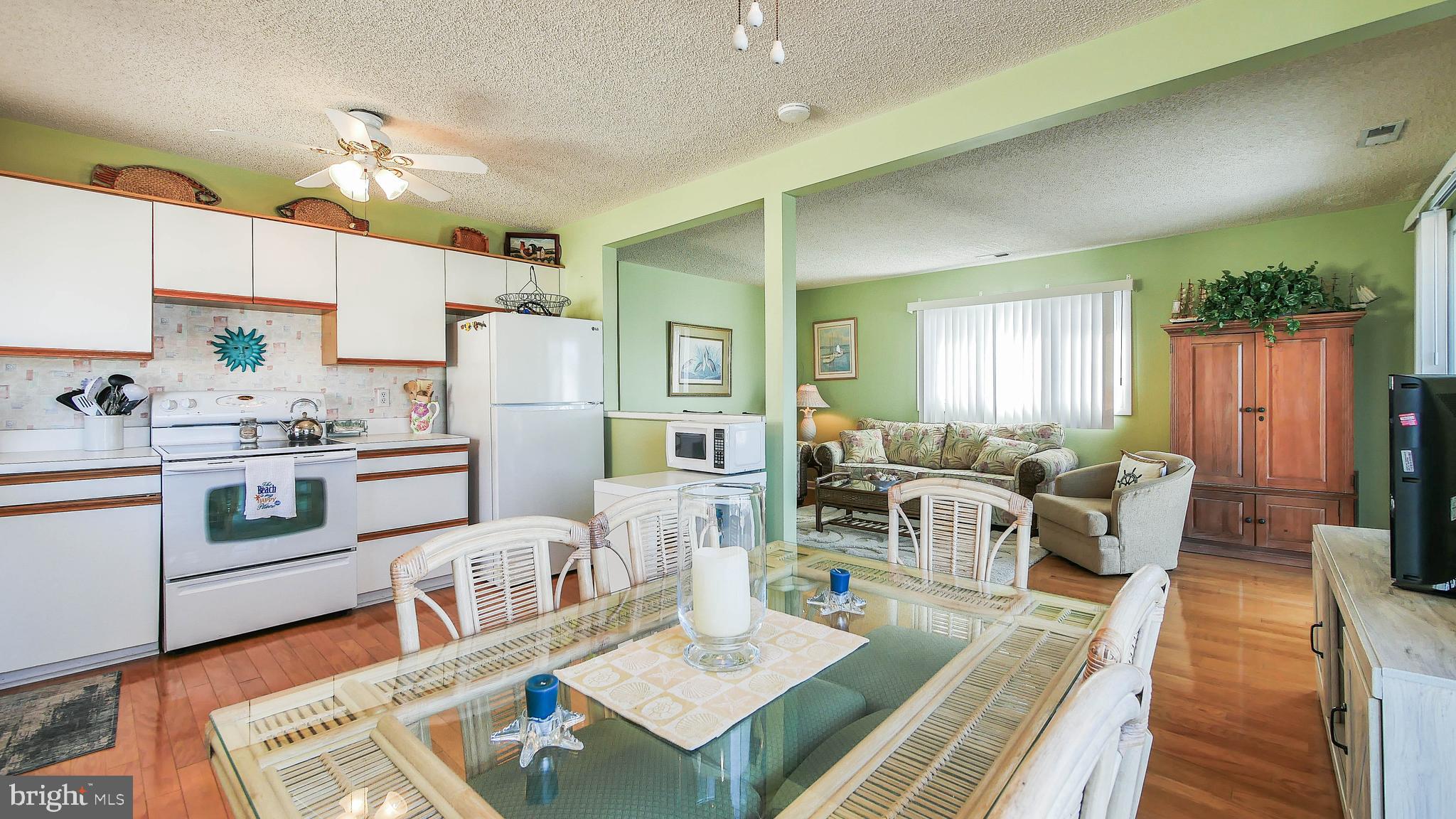 4025 4th Avenue Avalon, NJ 08202 - Photo 32 of 32 a living room with kitchen island furniture and a kitchen view