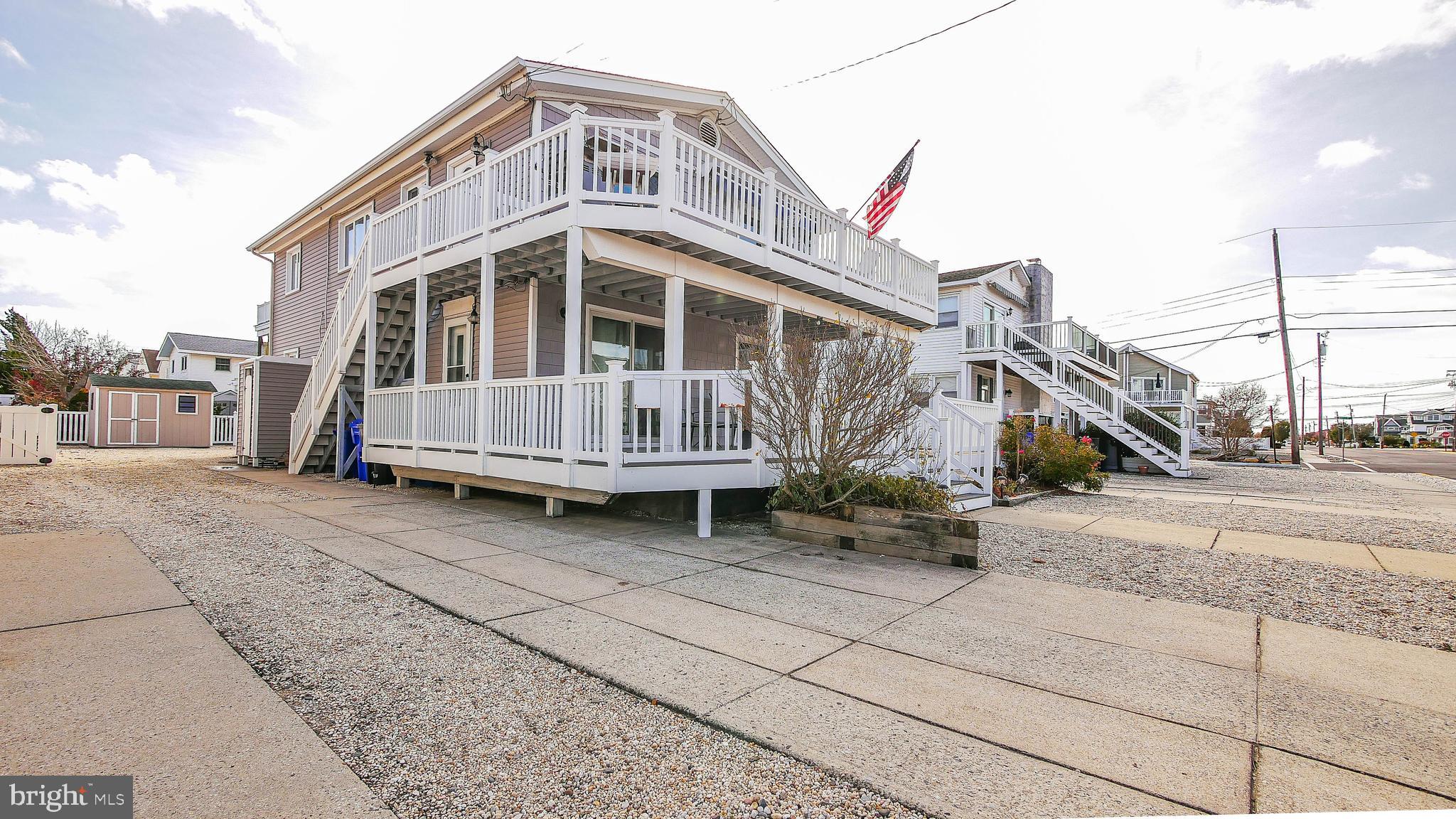 4025 4th Avenue Avalon, NJ 08202 - Photo 4 of 32 a view of a house with a wooden deck