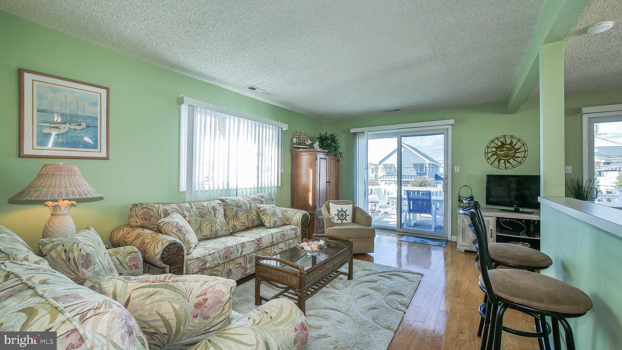 4025 4th Avenue Avalon, NJ 08202 - Photo 9 of 32 a living room with furniture and a large window