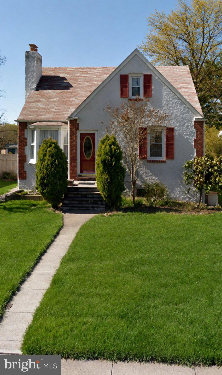 Charming home with lush green lawn.