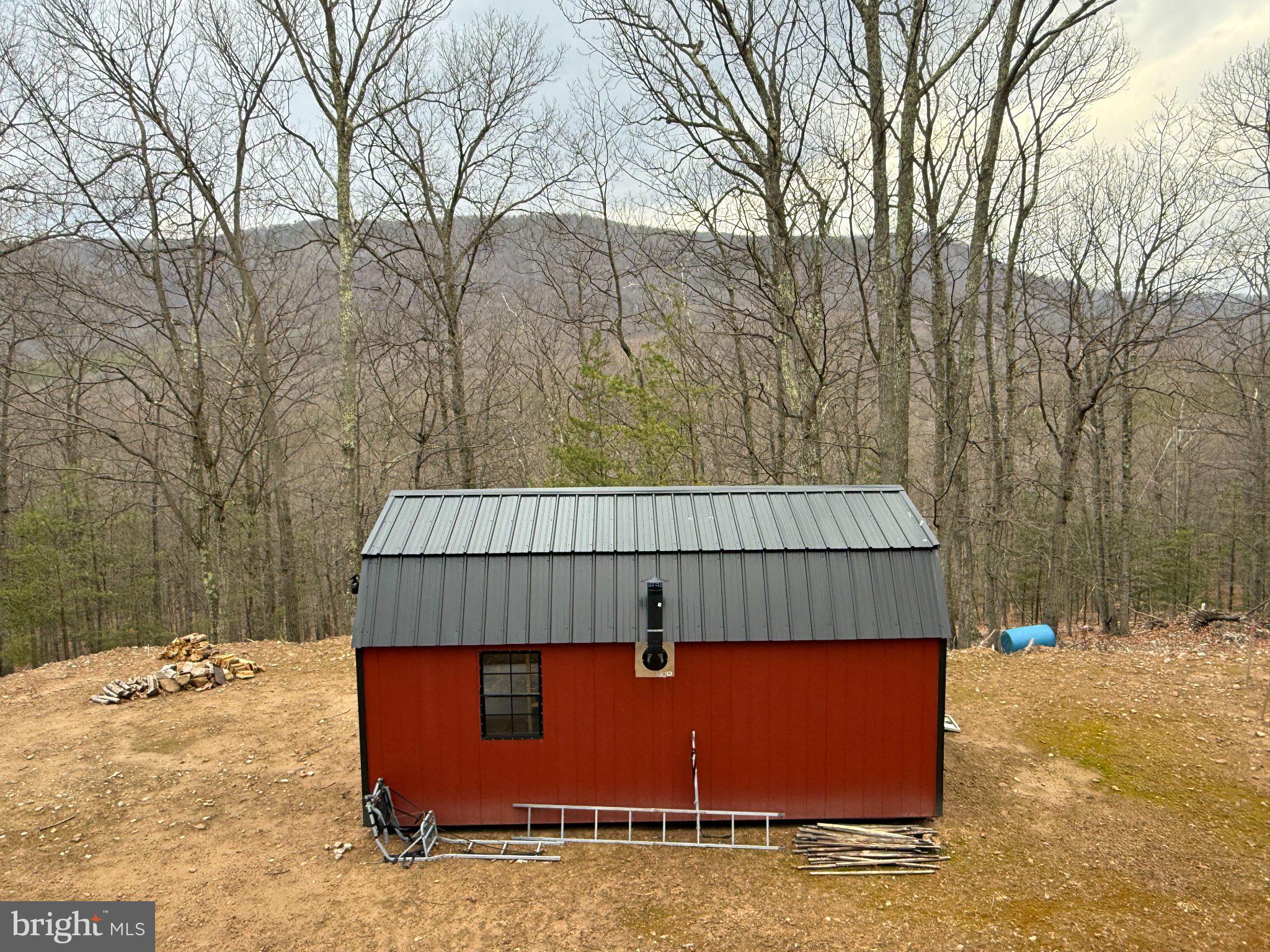 Advent Drive Augusta, WV 26704 - Photo 17 of 65 a view of backyard with a barn and a forest