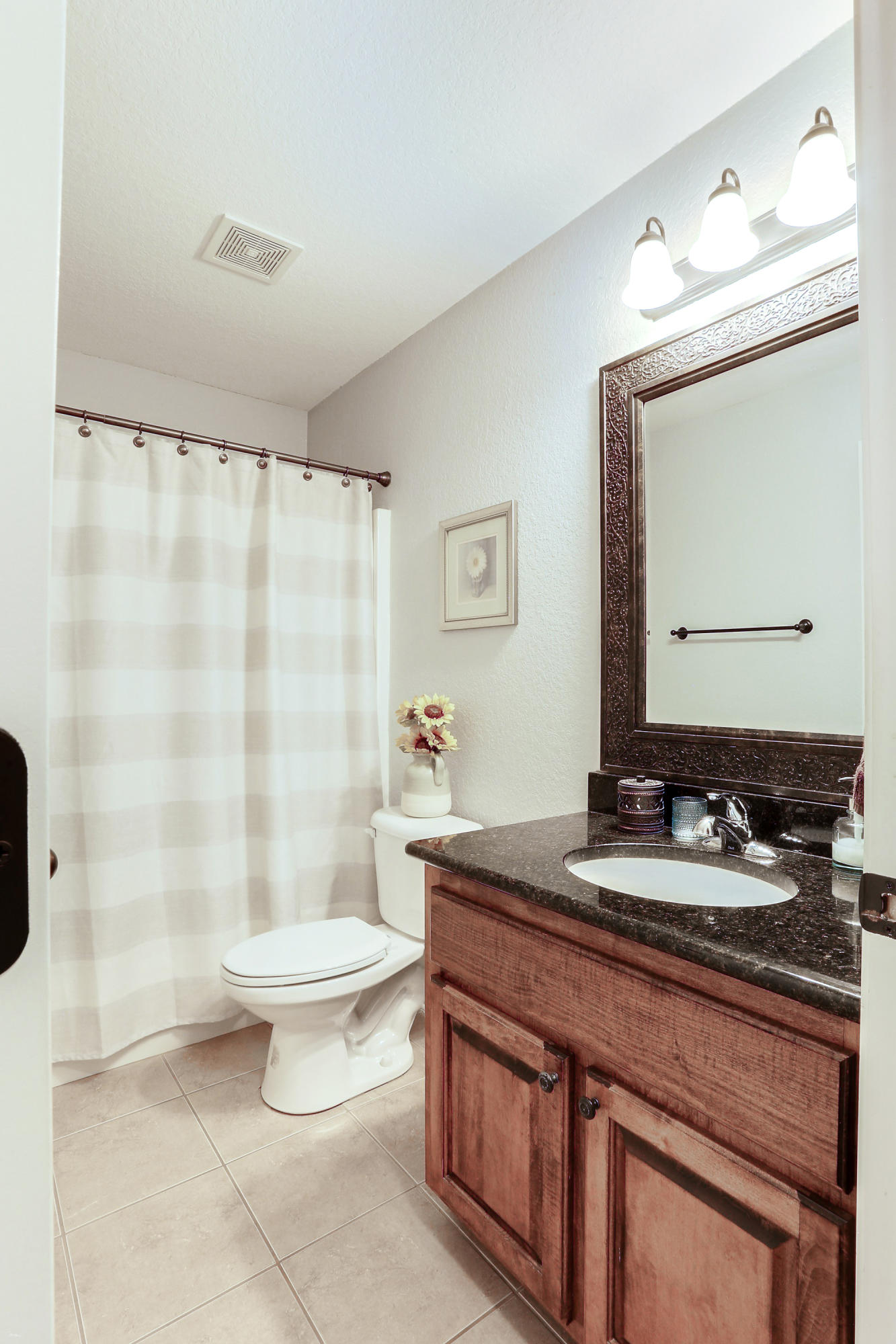 202 Pinque Coat Court Crestview, FL 32536 - Photo 15 of 35 a bathroom with a granite countertop sink a toilet a mirror and shower