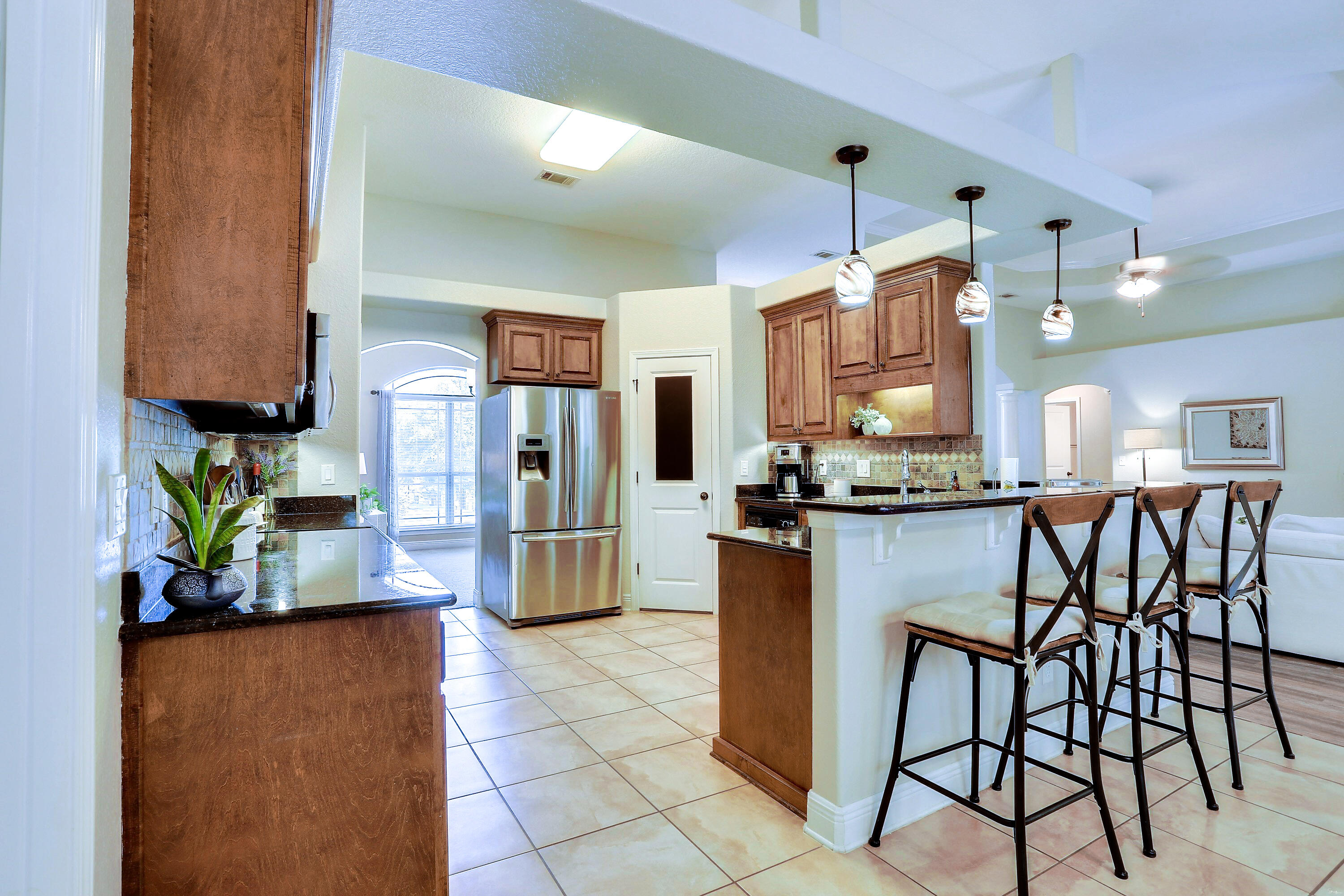 202 Pinque Coat Court Crestview, FL 32536 - Photo 17 of 35 a kitchen with stainless steel appliances kitchen island granite countertop dining table chairs and a refrigerator