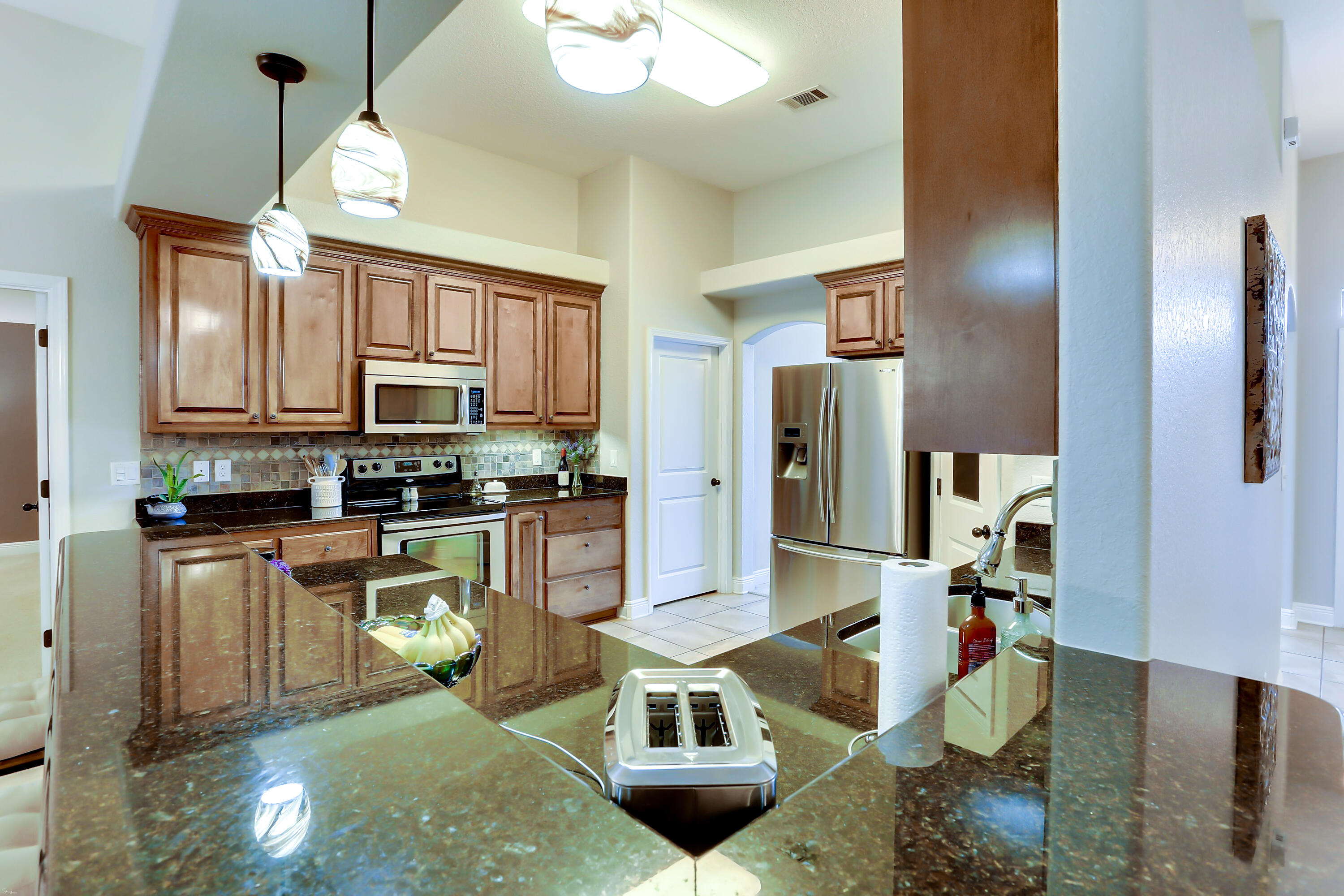 202 Pinque Coat Court Crestview, FL 32536 - Photo 18 of 35 a kitchen with stainless steel appliances granite countertop a refrigerator a stove and a sink with granite countertops