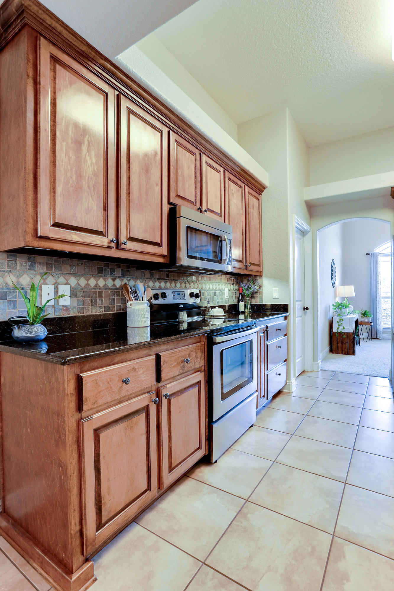 202 Pinque Coat Court Crestview, FL 32536 - Photo 19 of 35 a kitchen with stainless steel appliances granite countertop a stove a sink and a microwave