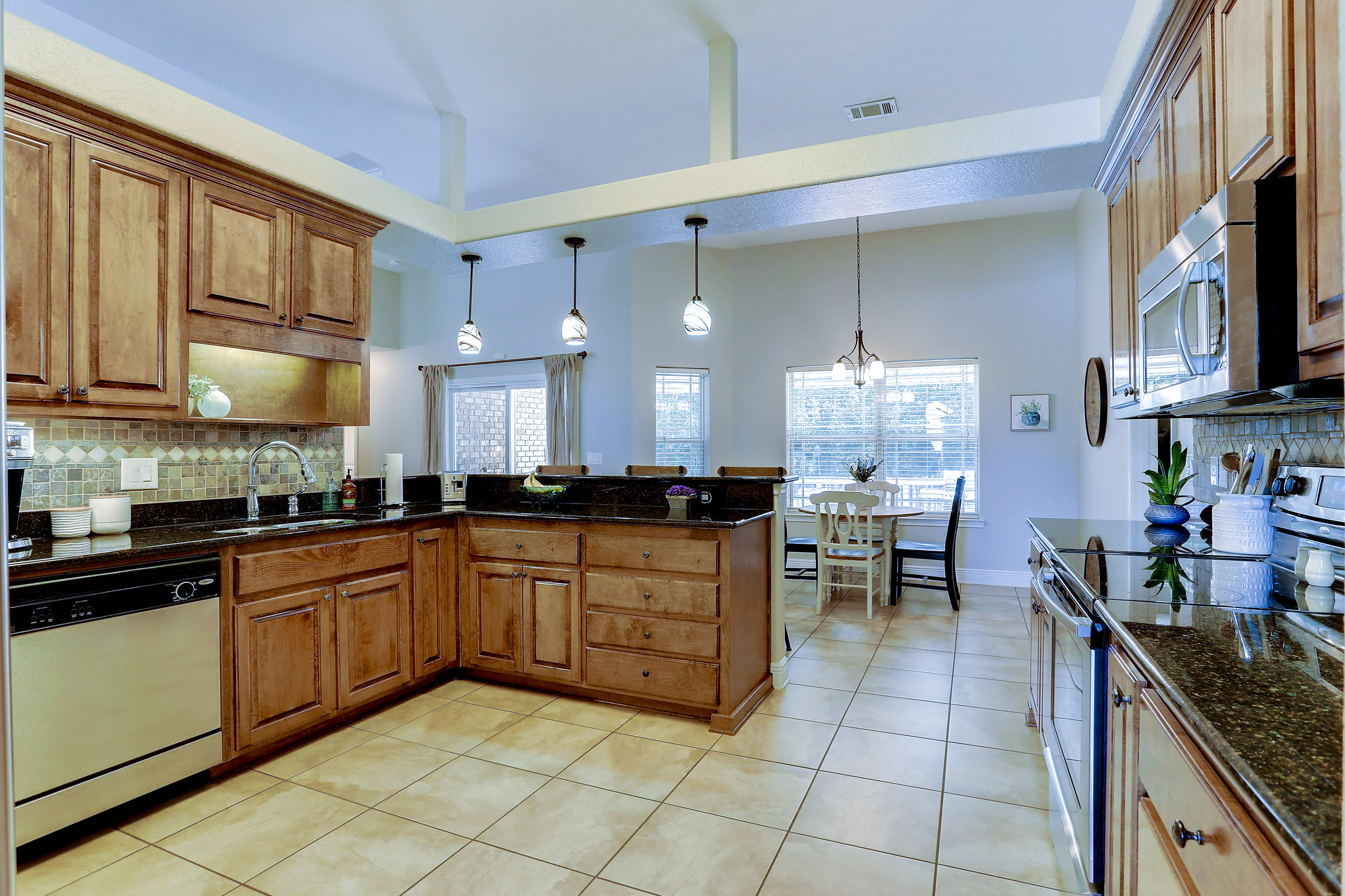 202 Pinque Coat Court Crestview, FL 32536 - Photo 20 of 35 a kitchen with stainless steel appliances granite countertop a sink and cabinets