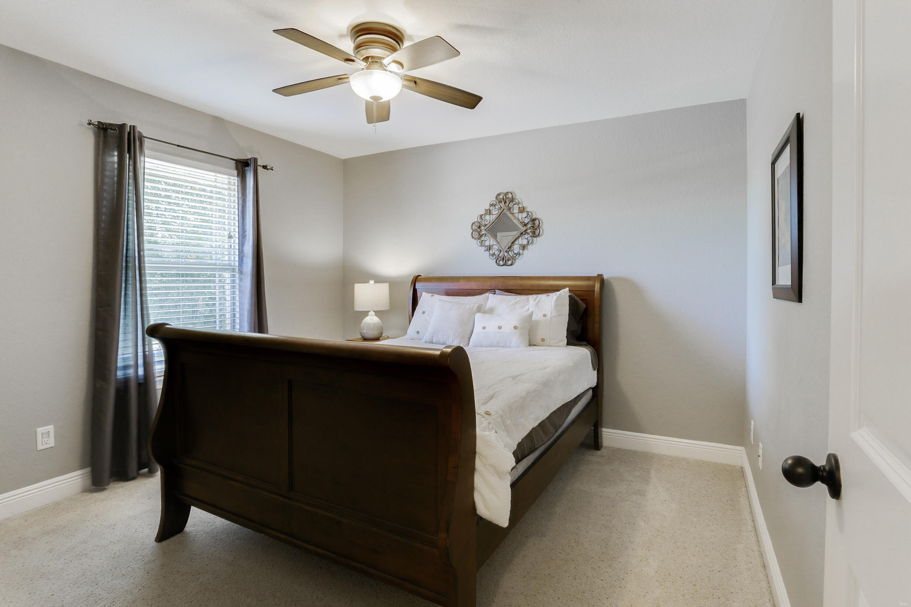 202 Pinque Coat Court Crestview, FL 32536 - Photo 21 of 35 a bedroom with a bed and a chandelier