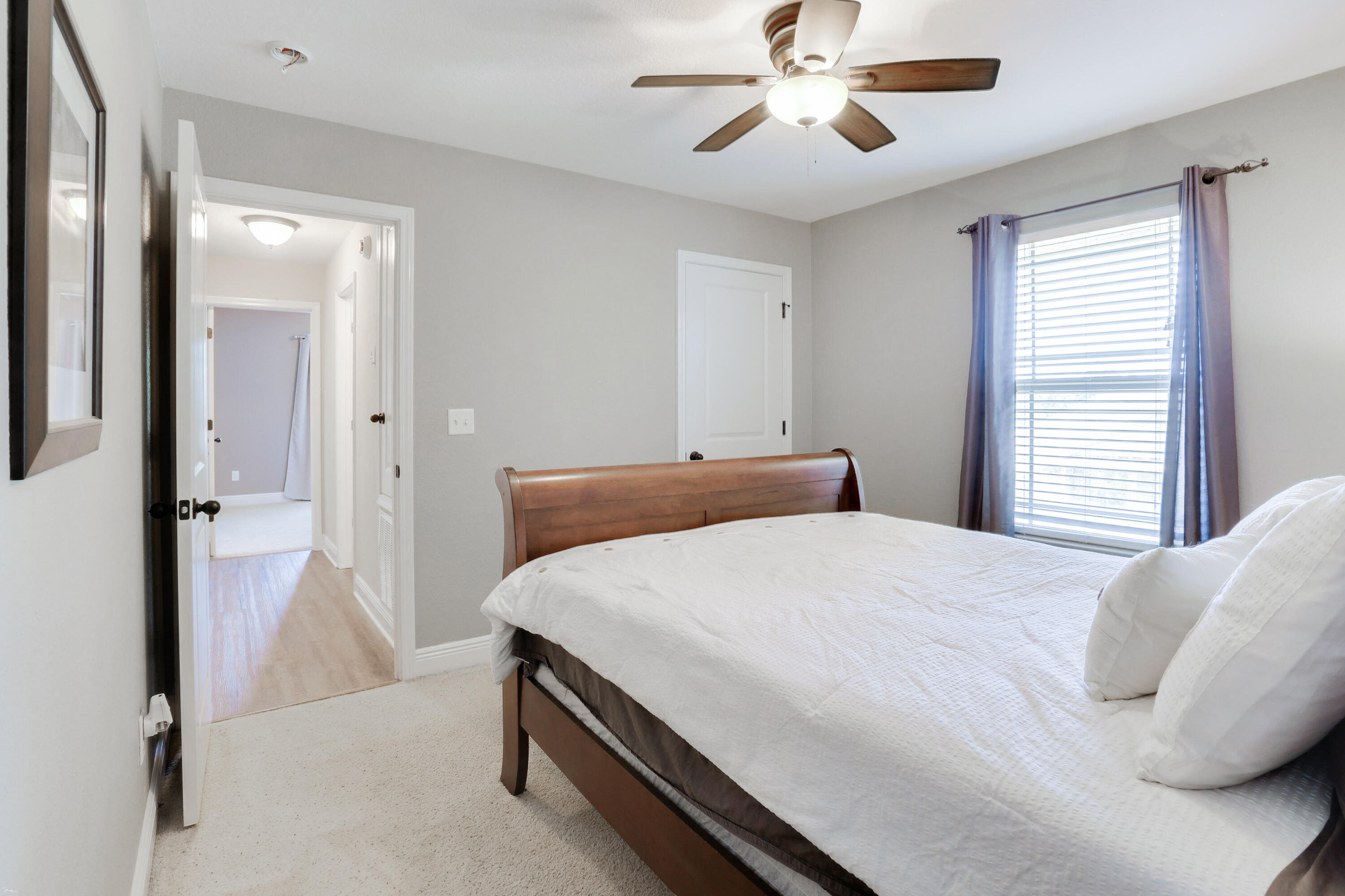 202 Pinque Coat Court Crestview, FL 32536 - Photo 22 of 35 a bedroom with a bed and a chandelier