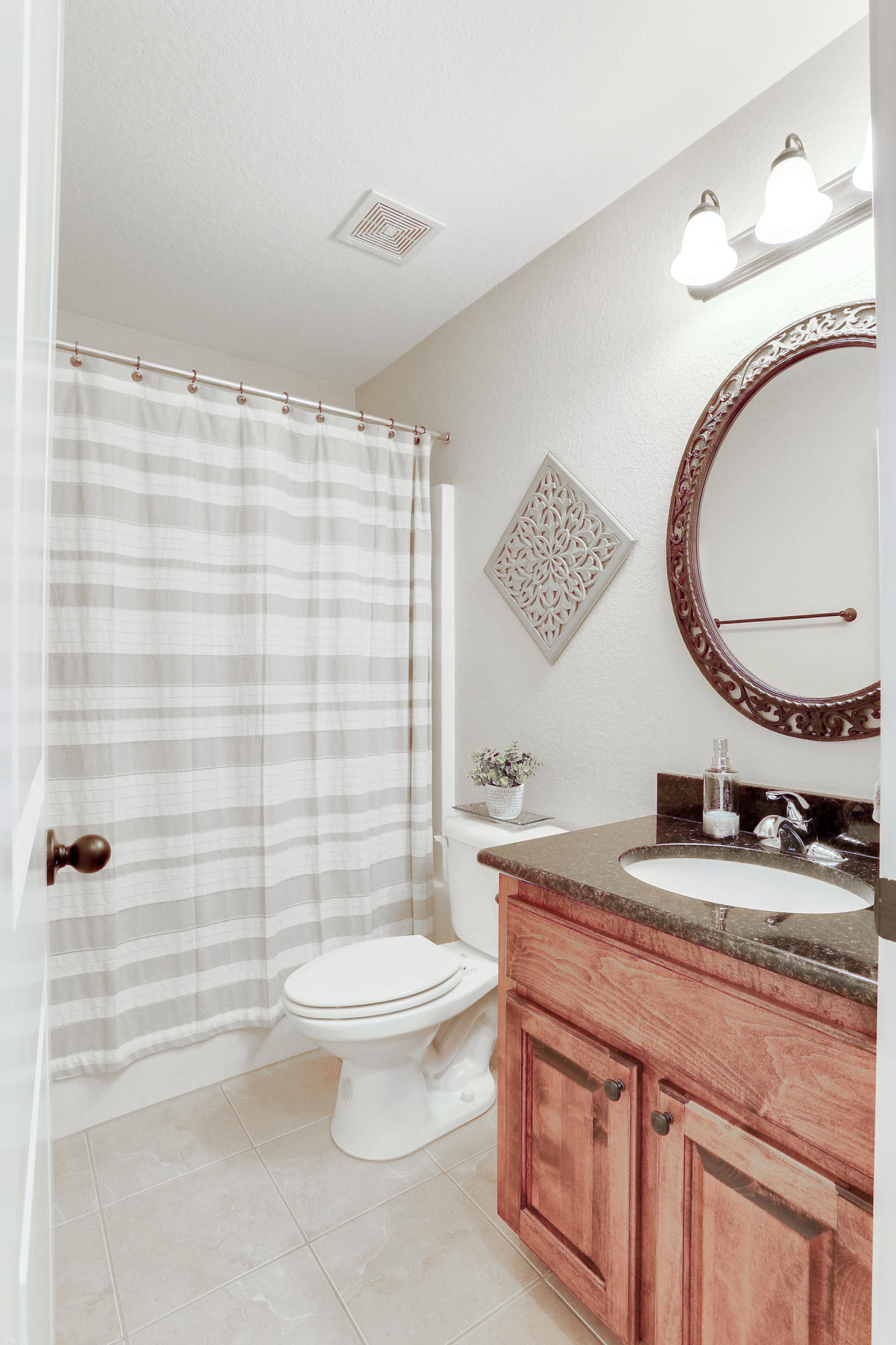 202 Pinque Coat Court Crestview, FL 32536 - Photo 23 of 35 a bathroom with a granite countertop toilet a sink and a mirror