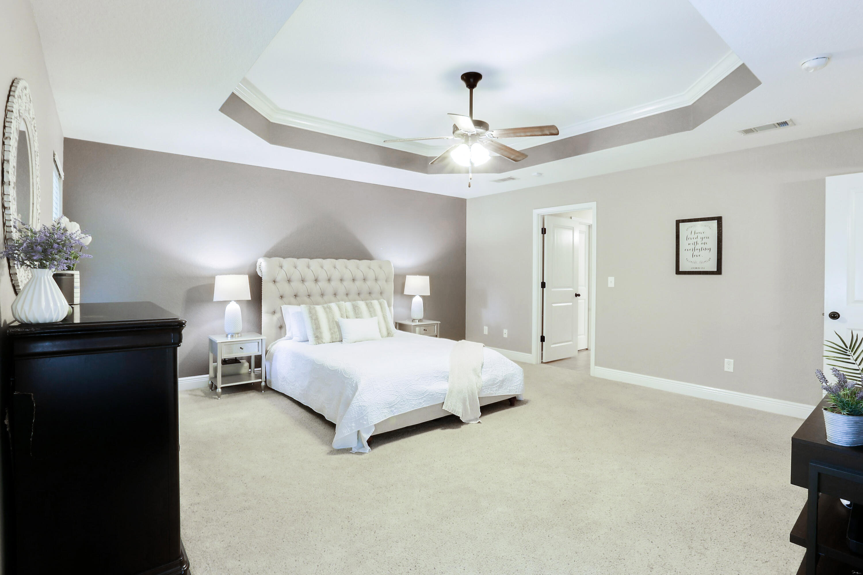 202 Pinque Coat Court Crestview, FL 32536 - Photo 27 of 35 a spacious bedroom with a bed and a lamp on the dresser
