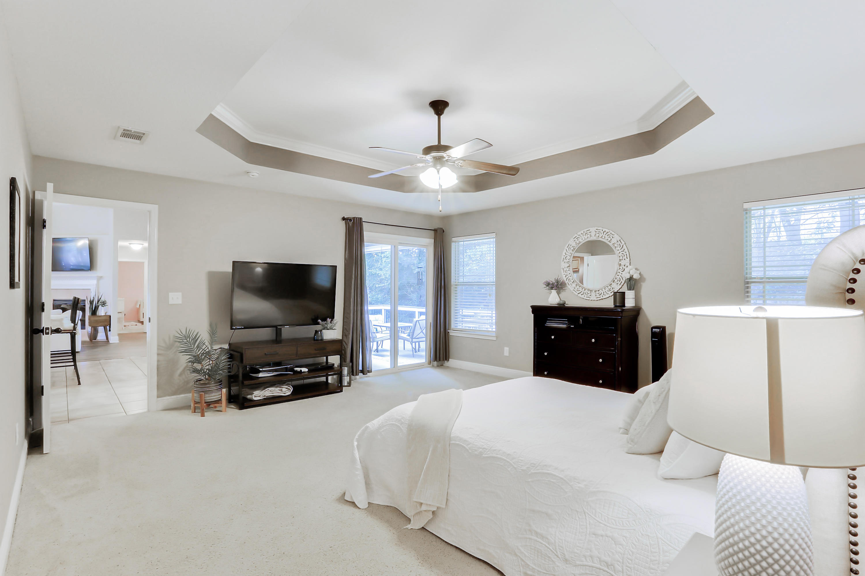 202 Pinque Coat Court Crestview, FL 32536 - Photo 31 of 35 a bedroom with a bed and a flat tv screen on wall