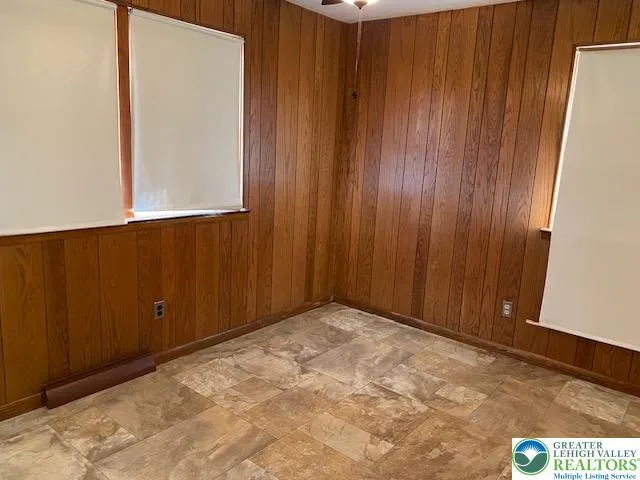 a view of an empty room with wooden wall