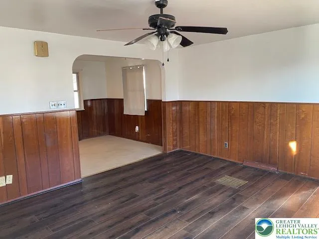 a view of a room with a cabinet and wooden floor
