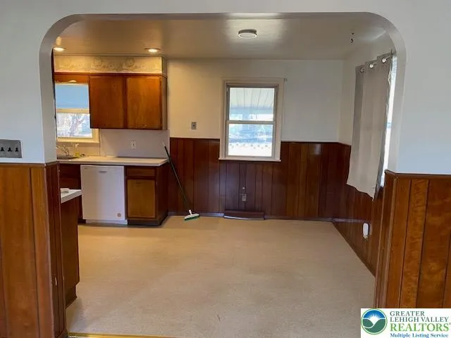 a kitchen with a refrigerator and window