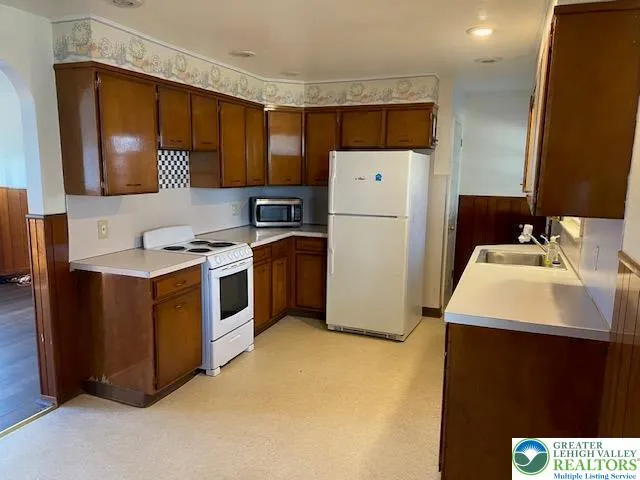 a utility room with sink a washer and dryer