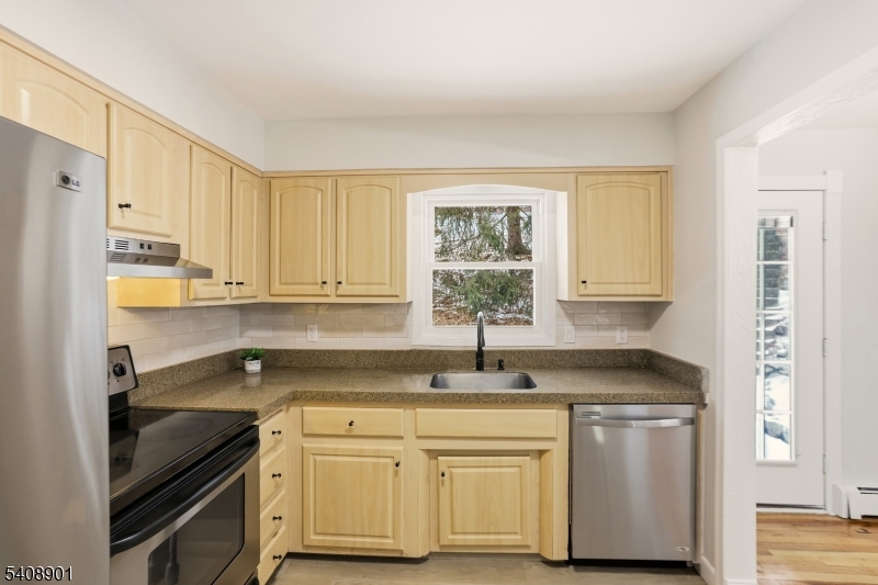 510 Davsel Road Landing, NJ 07850 - Photo 19 of 25 a kitchen with granite countertop white cabinets white appliances and sink