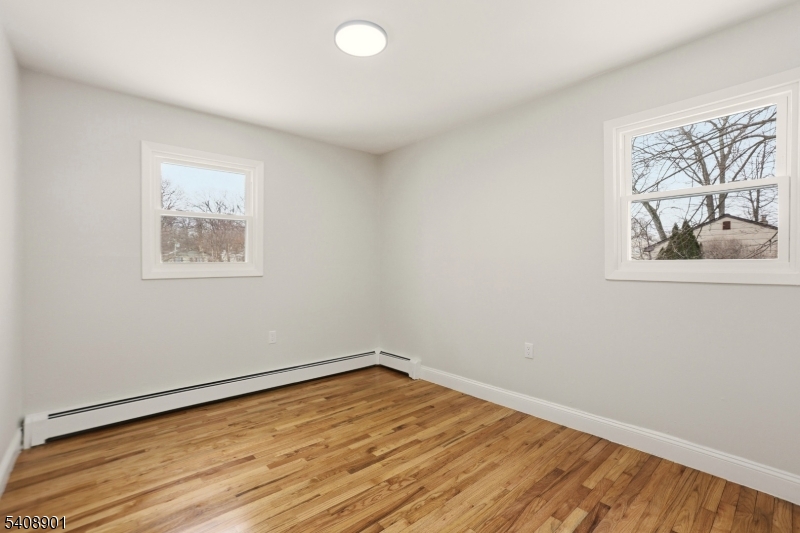 510 Davsel Road Landing, NJ 07850 - Photo 22 of 25 an empty room with a window and wooden floor