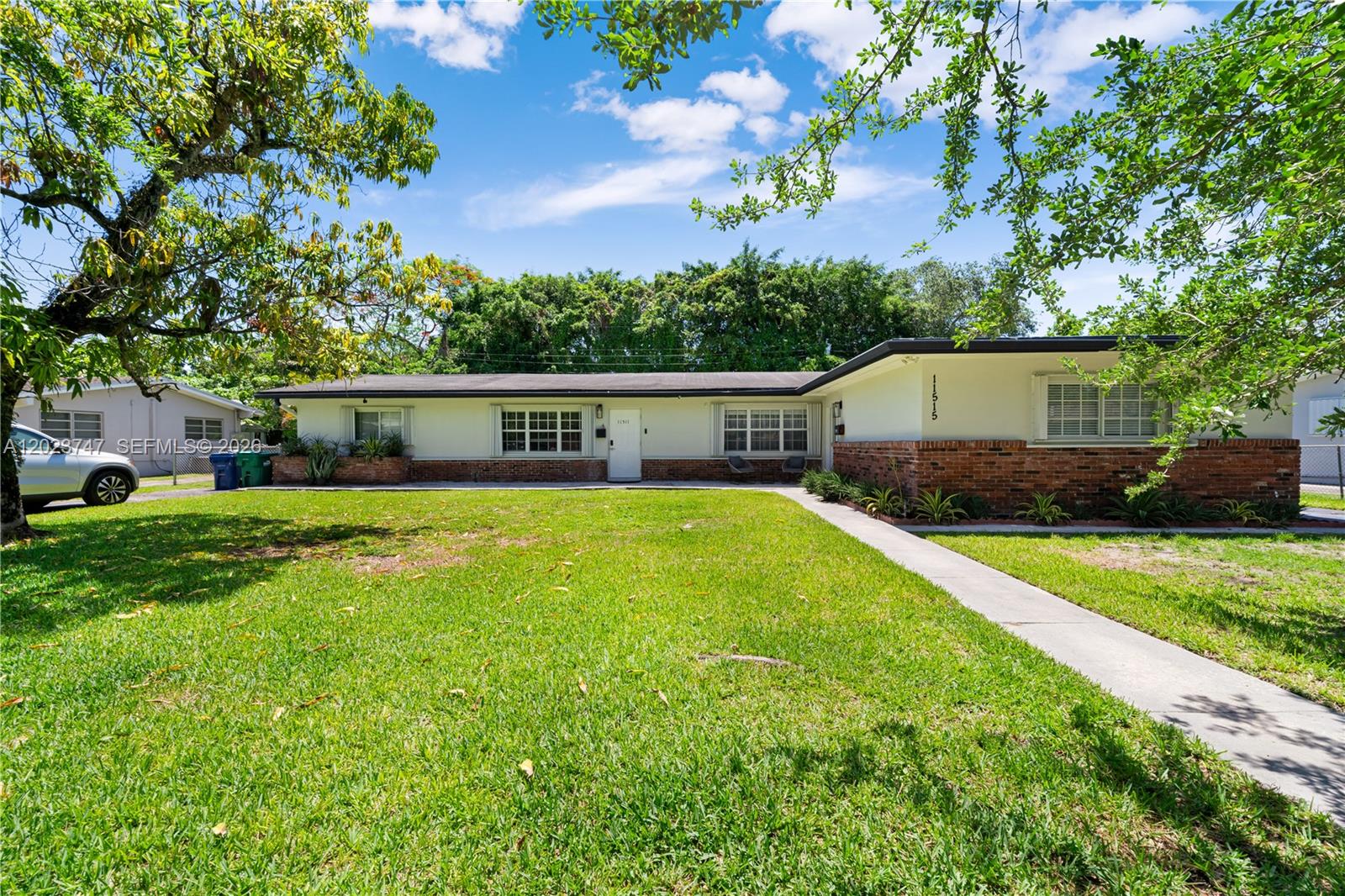 a view of house with backyard space and garden