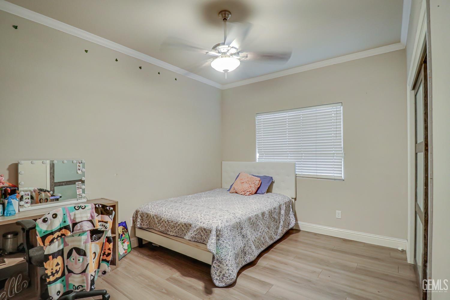 Undisclosed Address Bakersfield, CA 93313 - Photo 14 of 25 a bedroom with a bed and a chandelier