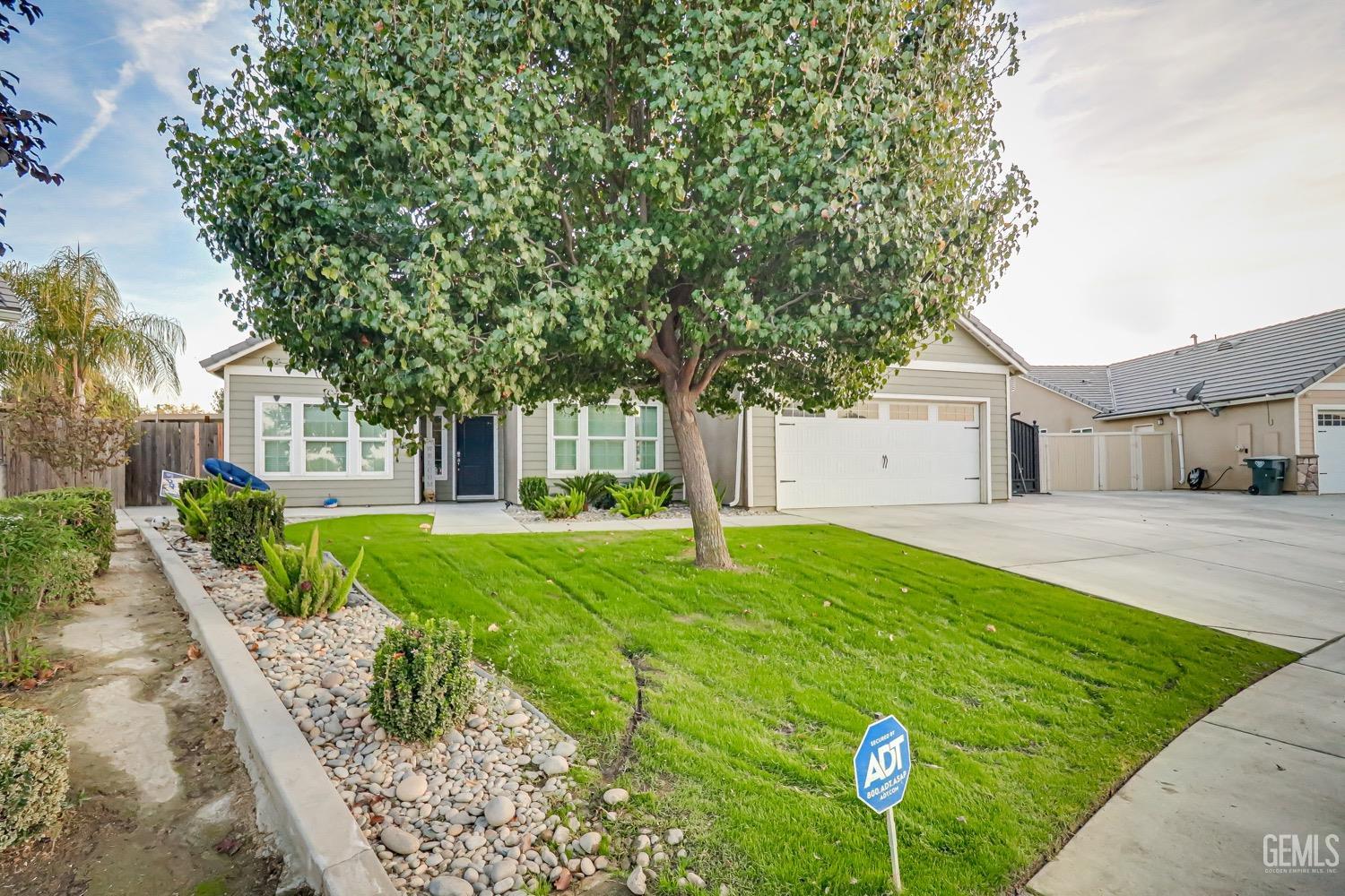 Undisclosed Address Bakersfield, CA 93313 - Photo 2 of 25 a front view of a house with garden