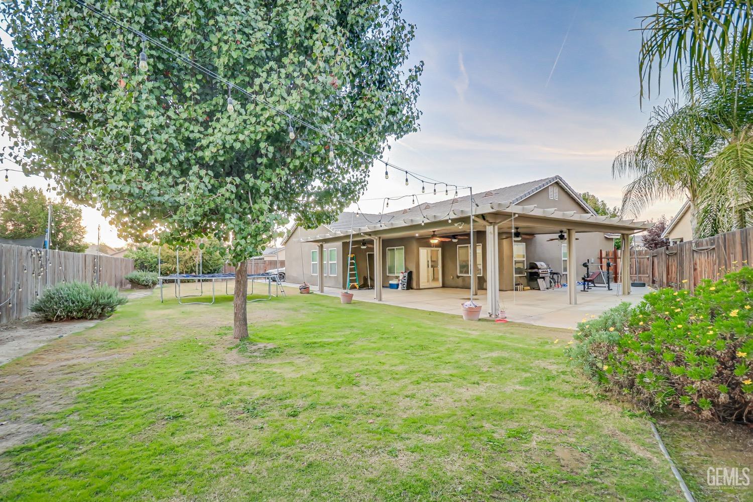 Undisclosed Address Bakersfield, CA 93313 - Photo 23 of 25 a front view of a house with yard patio and green space