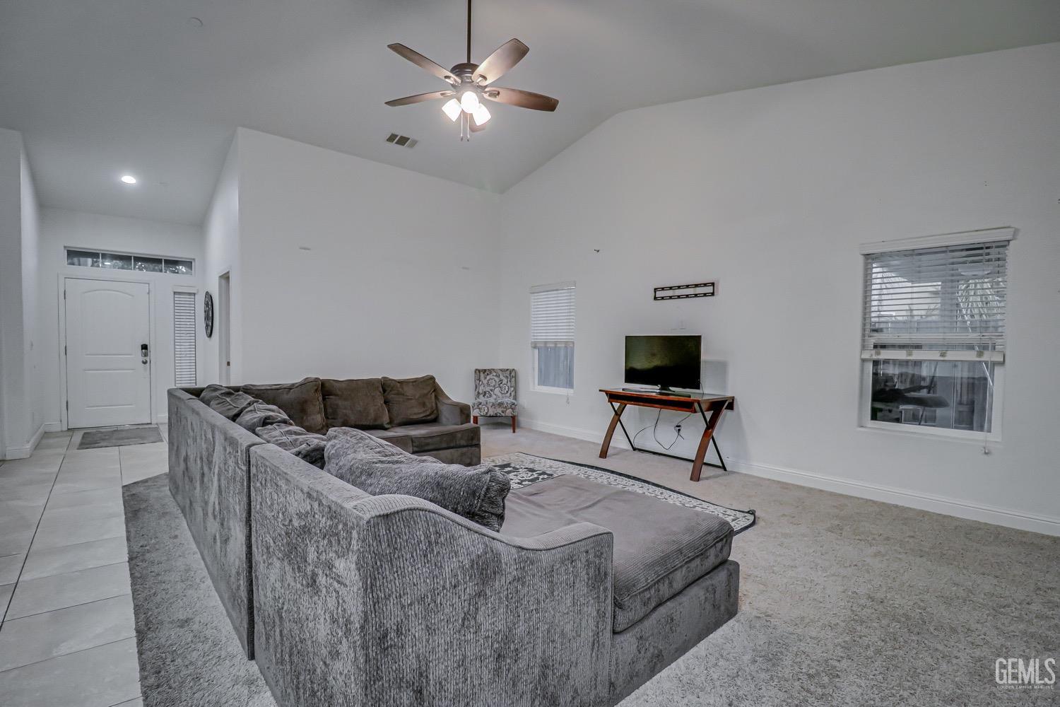 Undisclosed Address Bakersfield, CA 93313 - Photo 8 of 25 a living room with furniture and a flat screen tv