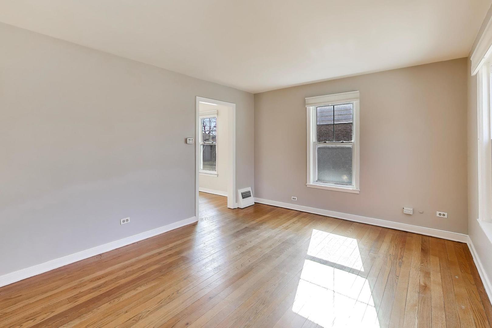 4023 Oak Avenue Brookfield, IL 60513 - Photo 2 of 17 an empty room with wooden floor and windows