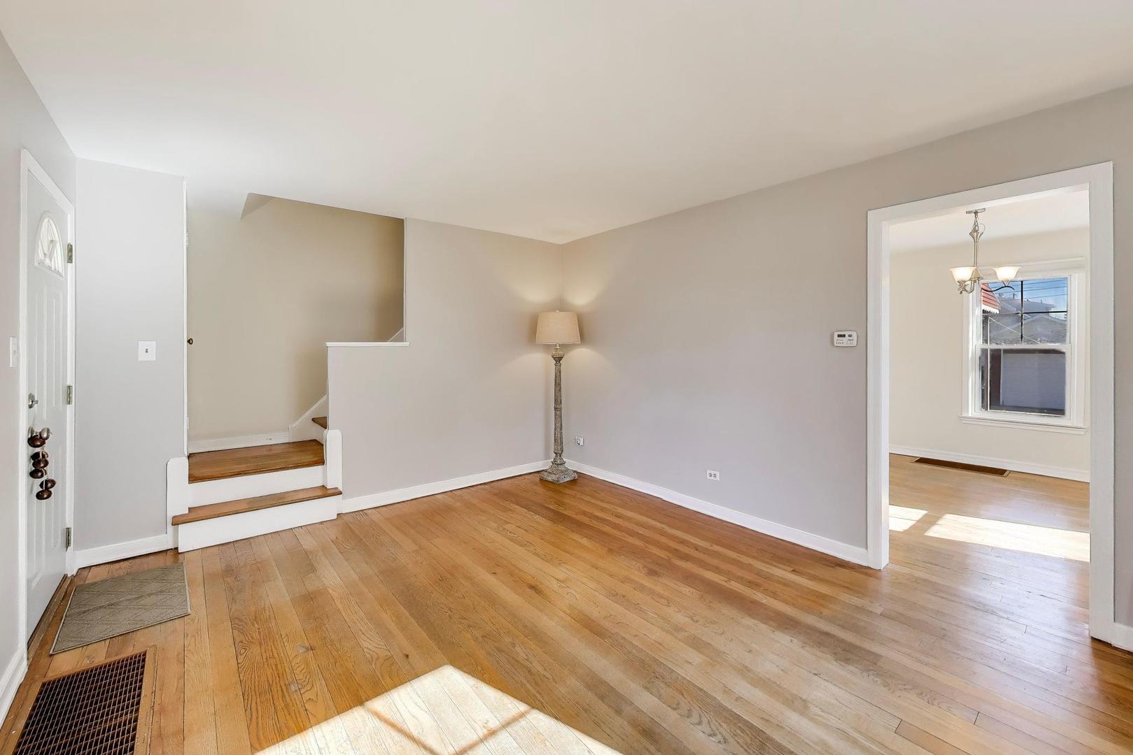 4023 Oak Avenue Brookfield, IL 60513 - Photo 4 of 17 a view of an empty room with window and wooden floor