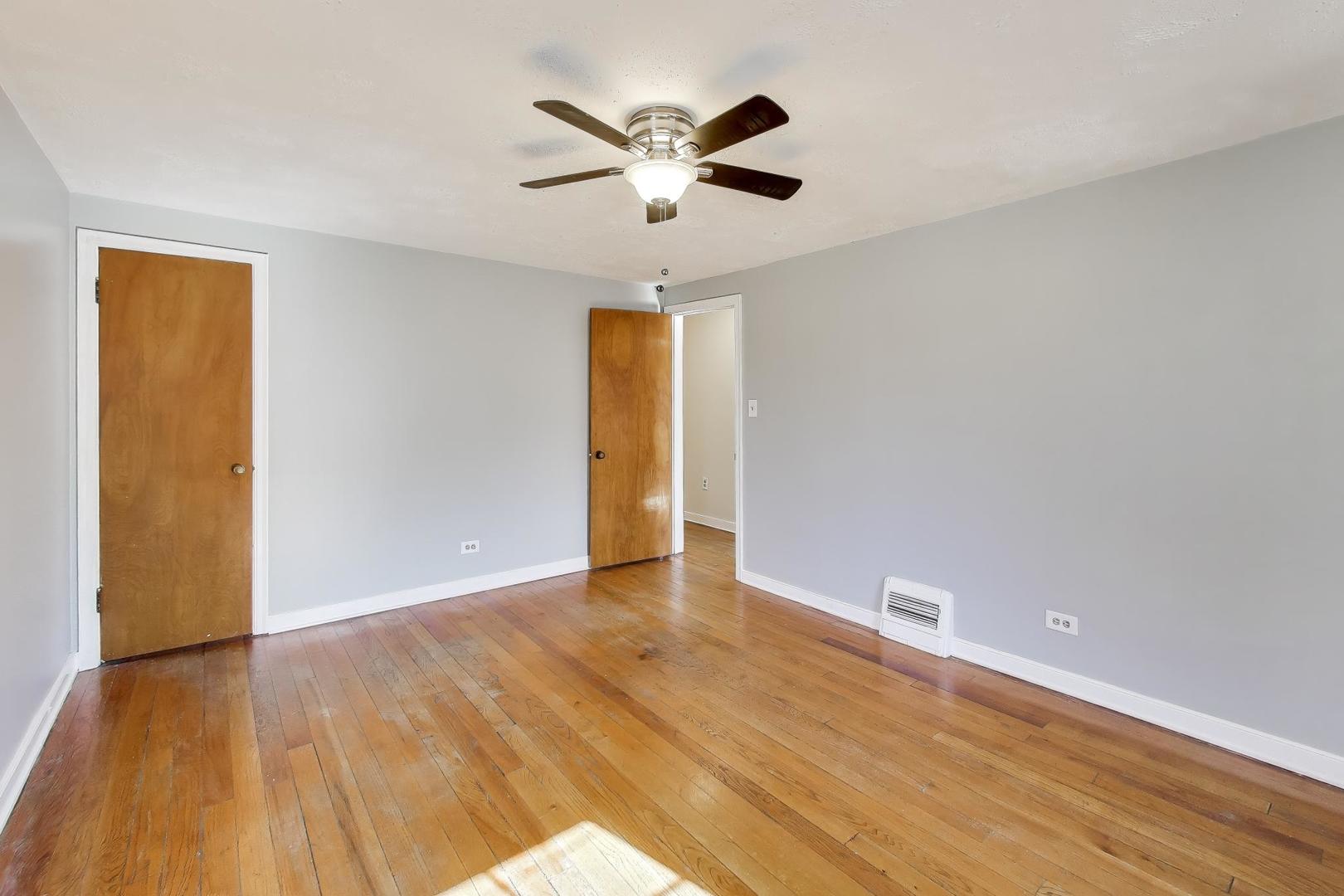 4023 Oak Avenue Brookfield, IL 60513 - Photo 9 of 17 a view of an empty room with wooden floor and a ceiling fan