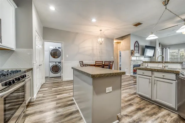 a kitchen with a sink and a stove top oven