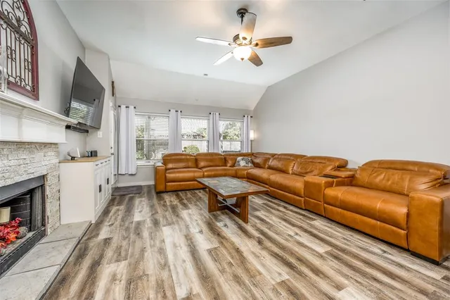 a living room with furniture fireplace and flat screen tv