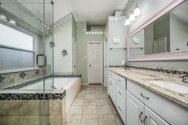 a spacious bathroom with a granite countertop sink mirror and a bath tub