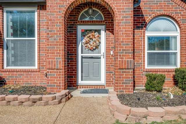 a front view of a house with plants