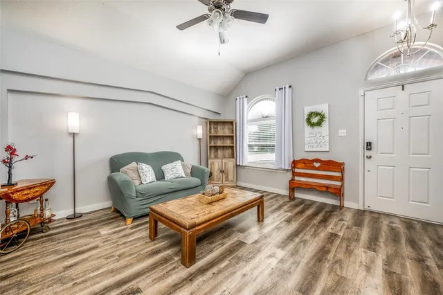a living room with furniture and wooden floor