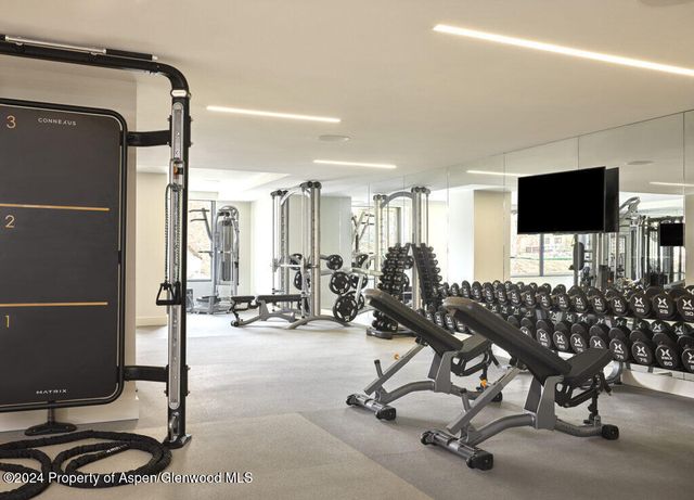 a view of a livingroom with workspace and a window