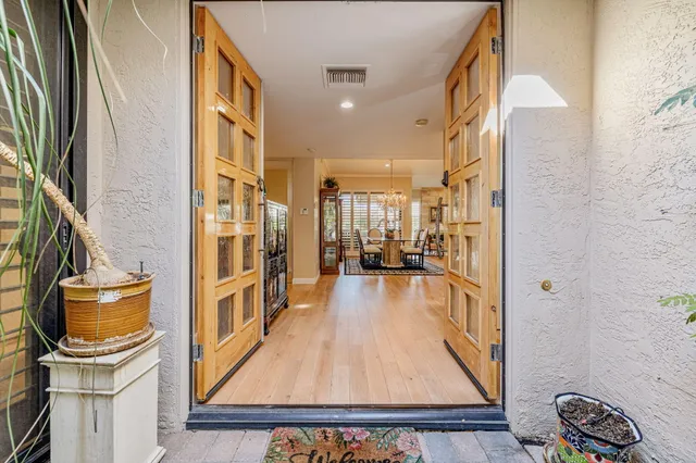 a living room with patio furniture and a potted plants
